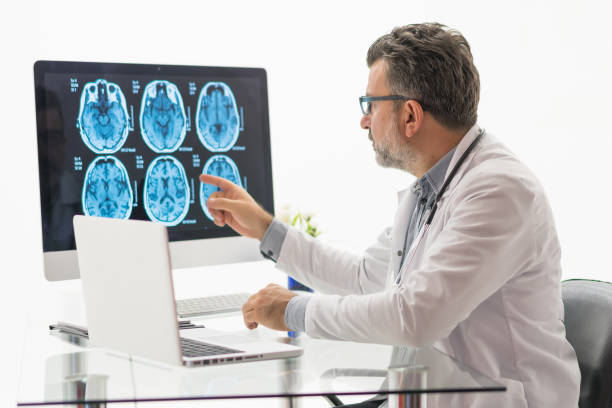istock Males doctor examining  brain MR 1180487612