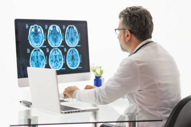 istock Males doctor examining  brain MR 1180488941
