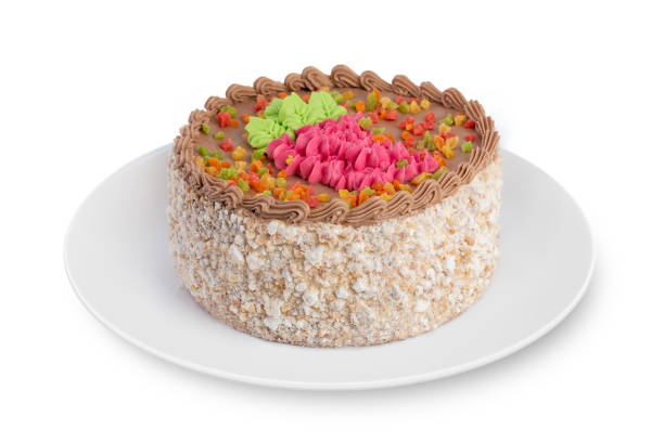 istock A round sponge biscuit cake with cream lies on a white plate on a white background. 1180489031