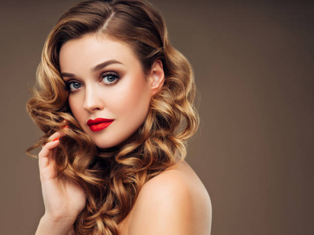 istock Girl applying red lipstick on her lips 1180489308