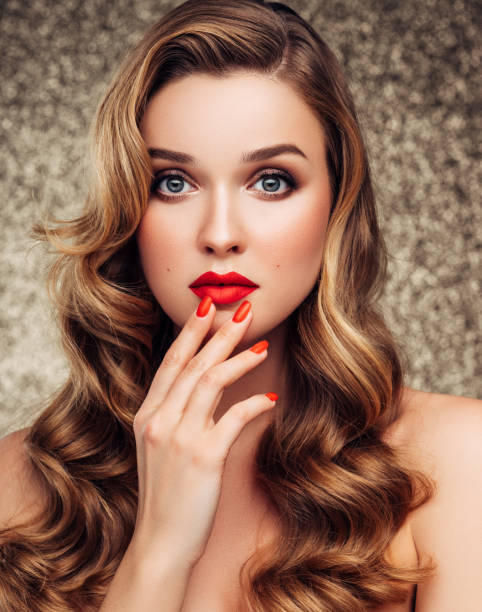 istock Girl applying red lipstick on her lips 1180492992
