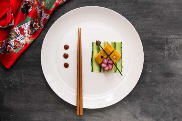 Tamagoyaki on a plate, top view stone background, copy space