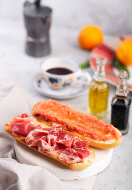 Spanish tomato and ham toast, traditional breakfast or lunch with coffee Spanish tomato and jamon toast, traditional breakfast or lunch spanish breakfast stock pictures, royalty-free photos & images