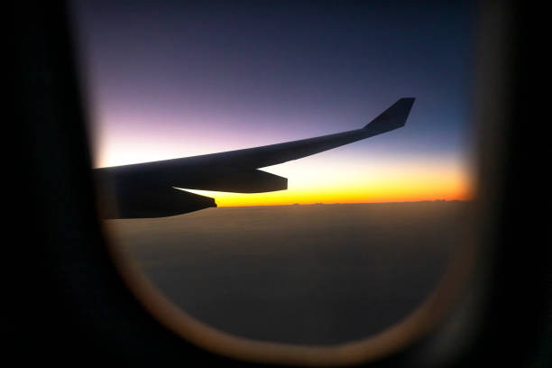 istock looking through plane window at colorful skyscape 1180503542