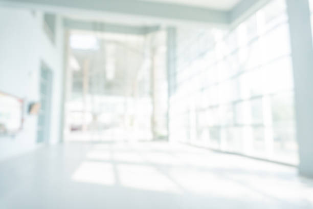 istock Abstract blurred white doctor medical office room background concept for blur empty space grey modern hospital clinic pharmacy, light clean interior retail sale, blue glare window hallway building 1180509253
