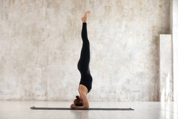 istock Beautiful woman practicing yoga, doing headstand exercise, salamba sirsasana 1180509446