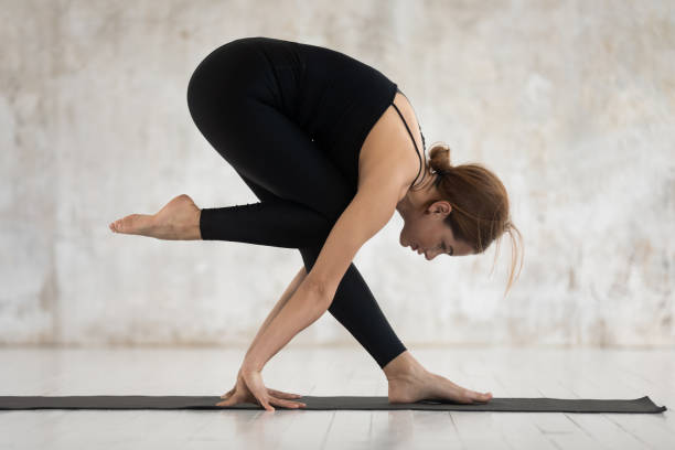 istock Beautiful young woman practicing yoga, preparation for handstand exercise 1180509448