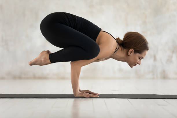 istock Beautiful woman practicing yoga, doing Crane exercise, Bakasana 1180509451