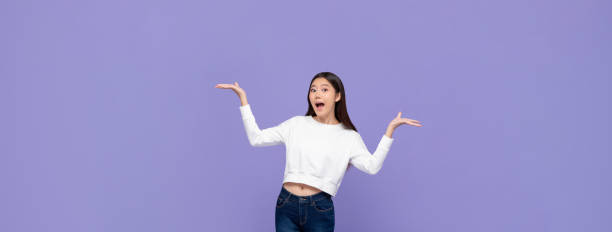 istock Excited Asian woman doing presenting gesture with both hands open 1180509709