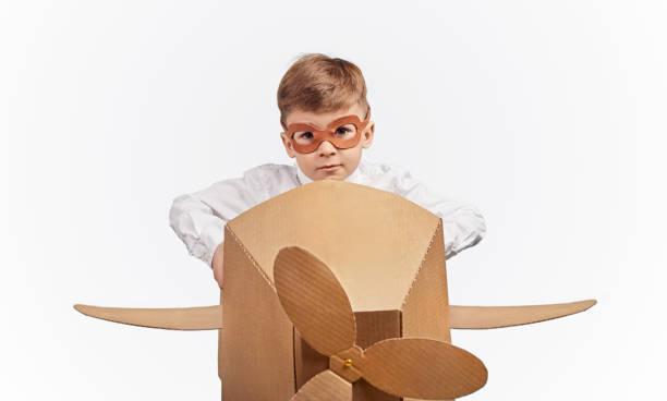 istock Kid with goggles pretending to be pilot 1180509714