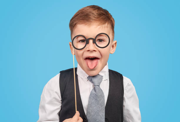 istock Boy in glasses showing tongue 1180509734
