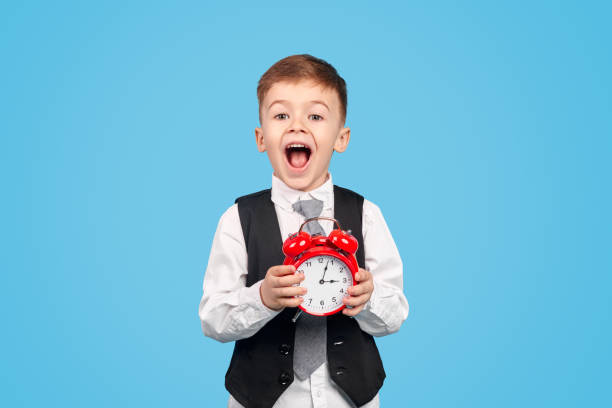 excited boy being late to studies - clock clock face blank isolated imagens e fotografias de stock