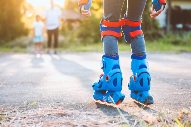 istock Kid riding on roller skates in the park 1180510181