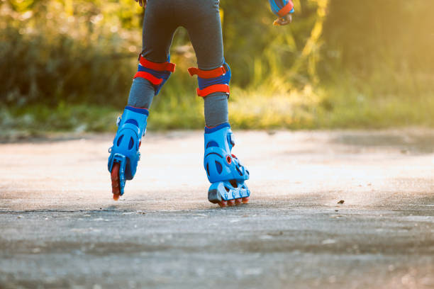 istock Kid riding on roller skates in the park 1180510701