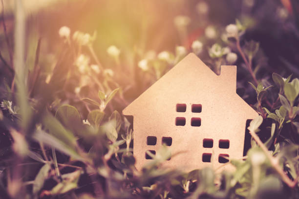 istock Closed up tiny home model on floor or wood board with grass background. Deam life have own house property for living or investment concept. 1180520863
