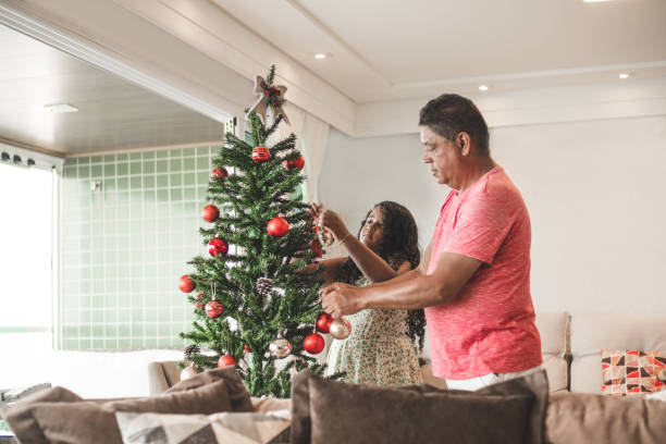 istock Father and daughter decorating the Christmas tree 1180524359