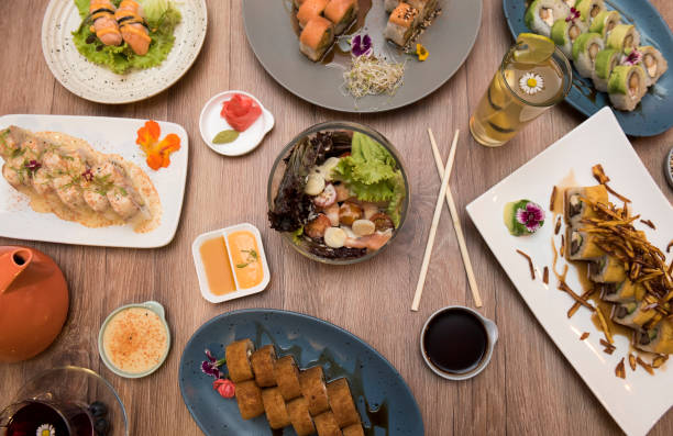 istock Japanese sushi set. Sashimi, maki rolls and green tea. 1180527398