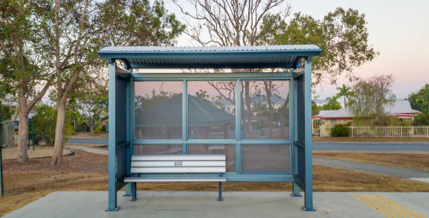 Bus Stop Shelter A bus stop shelter in front of a barbecue area in an Australian country town wind shelter stock pictures, royalty-free photos & images