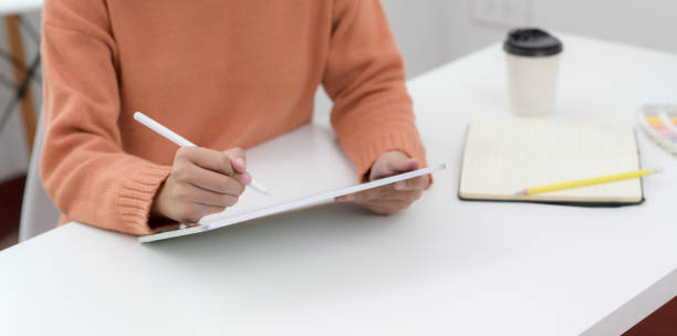 istock Cropped shot of young female working on her current project with tablet 1180529637