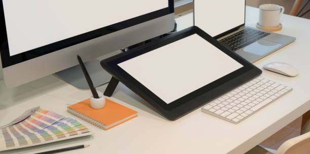 istock Close-up view of designer workplace with blank screen digital tablet with desktop computer 1180529684