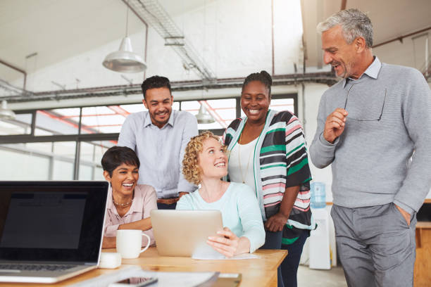 istock Smiling diverse businesspeople working together at an office table 1180531059