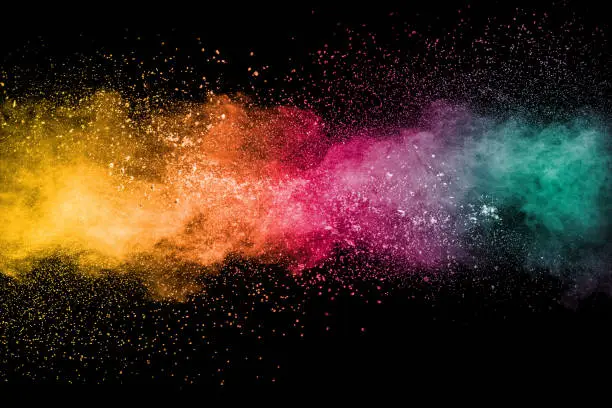 Photo of Colorful background of pastel powder explosion.Rainbow color dust splash on black background.