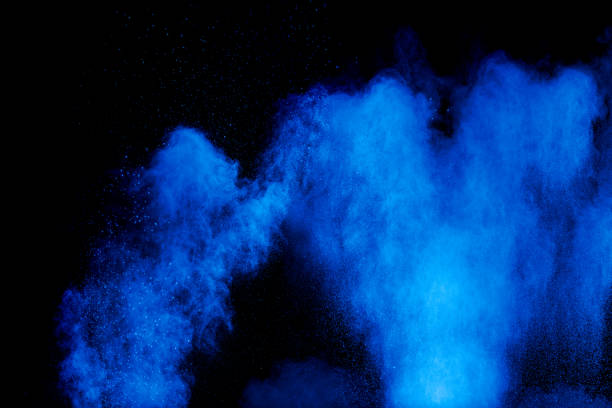 istock Blue color dust particles splash cloud on black background.Color powder explosion. 1180542166