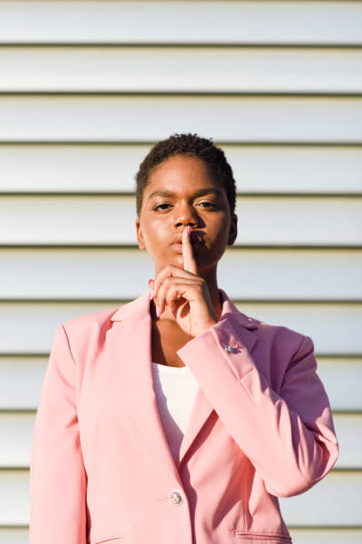 istock African American business woman doing silence gesture. 1180546554