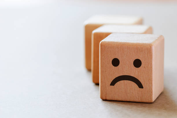 istock Sad wooden dices with unhappy face 1180548354
