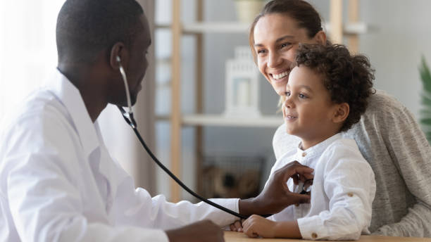 African male pediatrician hold stethoscope exam child boy patient African male pediatrician hold stethoscope exam child boy patient visit doctor with mother, black paediatrician check heart lungs of kid do pediatric checkup in hospital children medical care concept pediatrician stock pictures, royalty-free photos & images