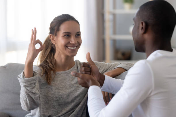 istock Happy mixed race deaf couple using sign language for communication 1180549313