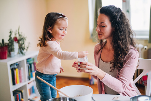 Mother learning her daughter to cook