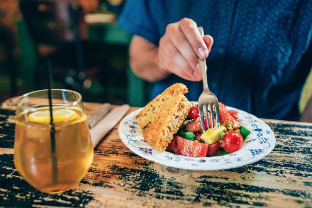 istock Young man eating organic healthy salad 1180552895