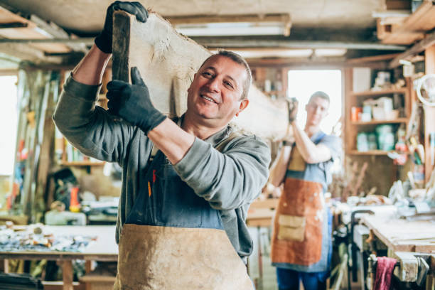 istock Carpenters carrying a wood plank 1180553981