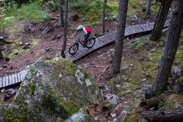 istock Mountain bike rider rides down the technical trails 1180555420
