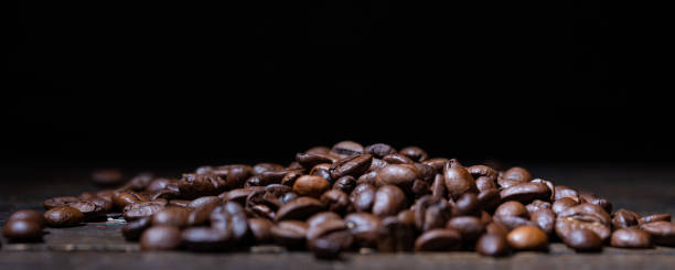 istock Coffee beans on a wooden table 1180555463