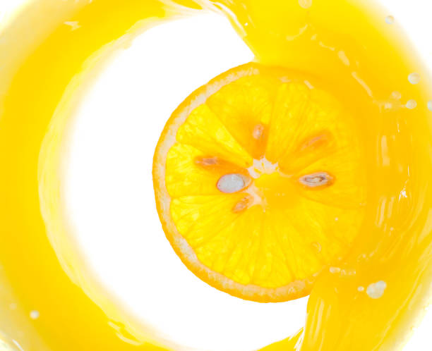 istock a piece of orange will fall into juice and spray, top view 1180555622
