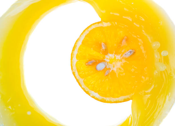 istock a piece of orange will fall into juice and spray, top view 1180555649