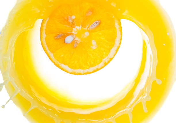 istock a piece of orange will fall into juice and spray, top view 1180555705