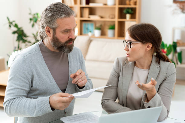 istock Mature client specifying details of contract while consulting with agent 1180557811