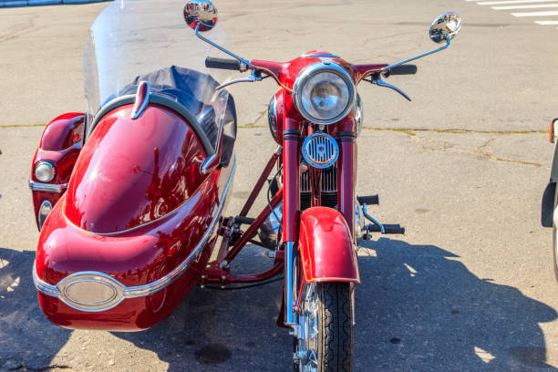 an old red motorcycle on a bright summer day in the village
