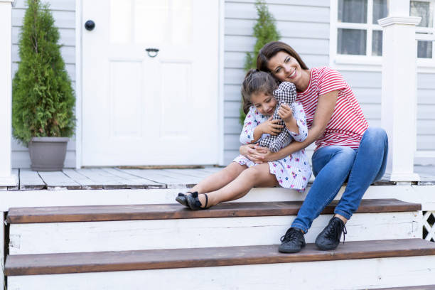 istock Mother and daughter having fun in back yard 1180559019