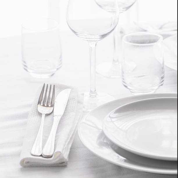 istock Table setting with white plates, silver cutlery and glasses for elegant festive dinner. Dinning concept background. 1180560489