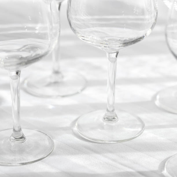 istock Several empty wine glasses in white grey shades on the white tablecloth for abstract background 1180560497