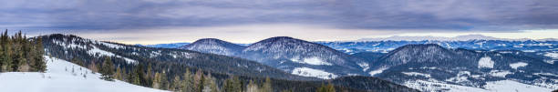 Mountain peak with snow blow by wind. Winter landscape. Cold day, with snow shining in the sun.