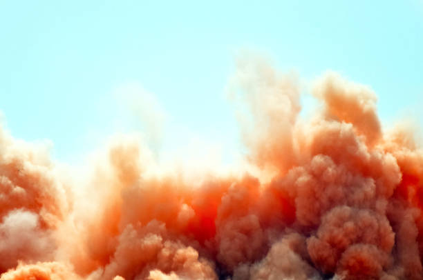 Red clouds of the dust Dust clouds and rock particles during blast on the construction site dust storm stock pictures, royalty-free photos & images