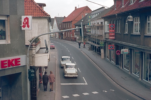 Lohne, Lower Saxony, Germany, 1970. Street scene in Provence town Lohne. Furthermore: pedestrians, cars, shops and buildings.