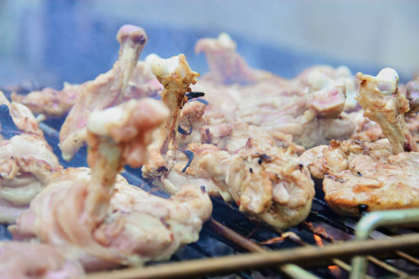 istock Raw chicken on the grill 1180567951