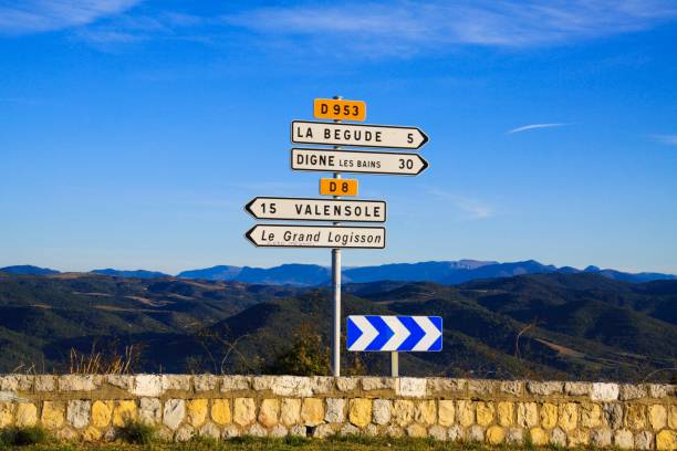 istock View on white isolated direction signs arrow with endless valley and stone wall against blue sky - Provence, France, Gorges du Verdon 1180570052