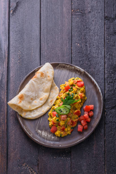 istock Indian omelette with spices and tomatoes, copy space 1180570275